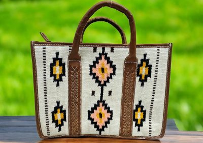 Handwoven wool and leather tote bag with Aztec geometric pattern in earthy tones